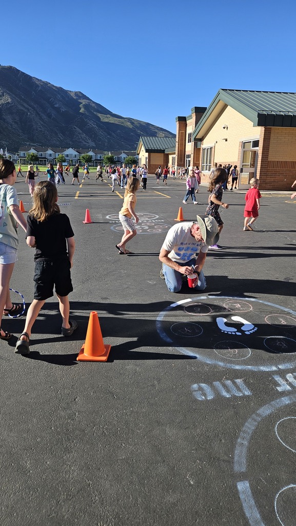 a volunteer painting on the blacktop