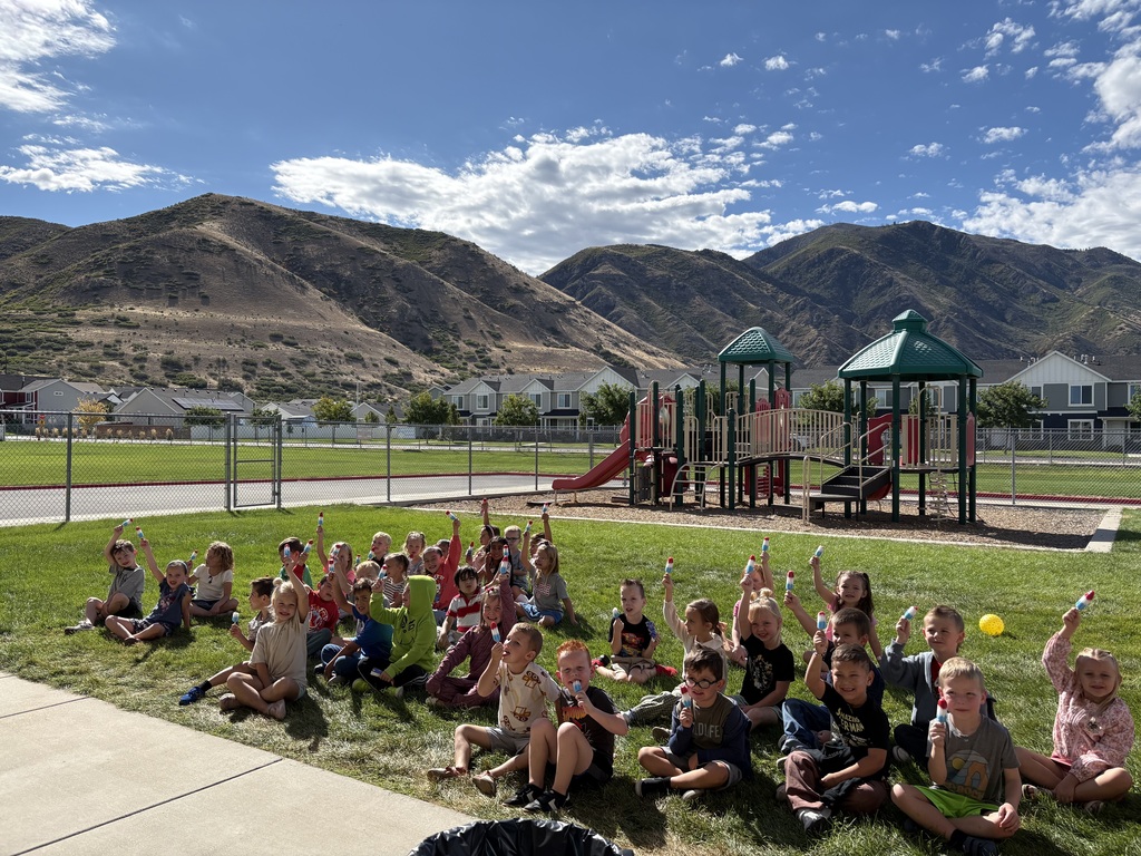kindergartners holding up popsicles