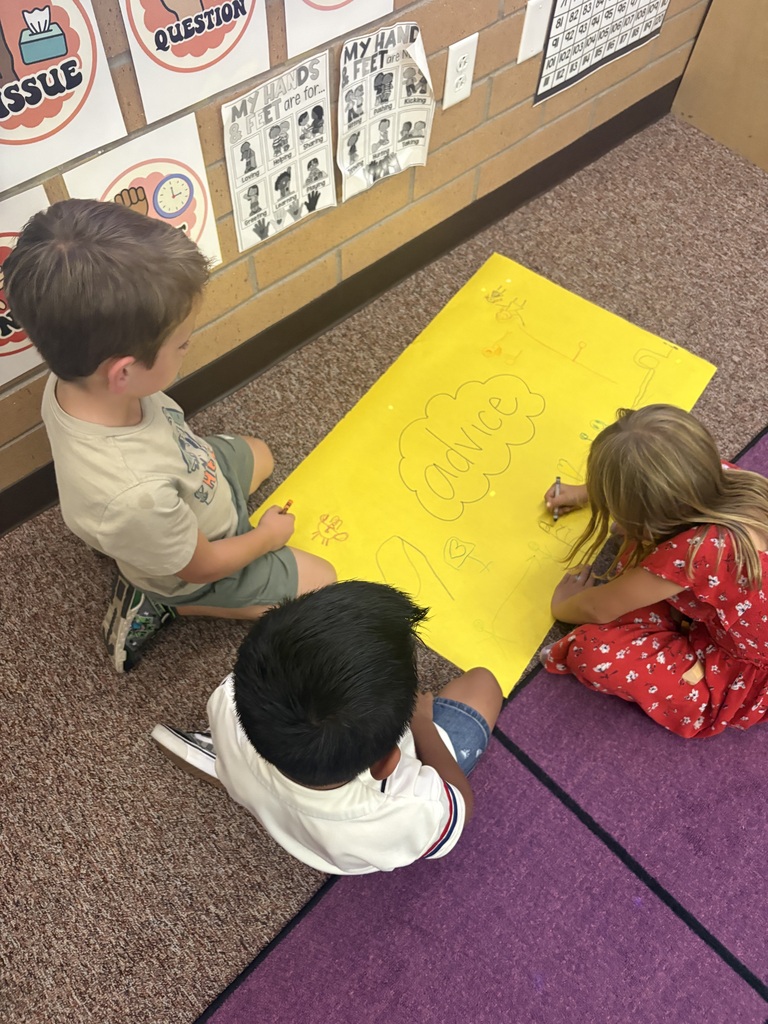 students writing on a poster together