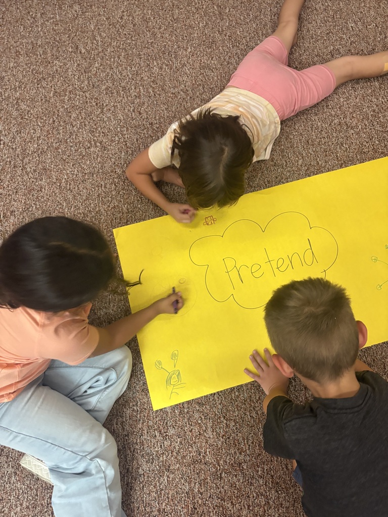 students writing on a poster together