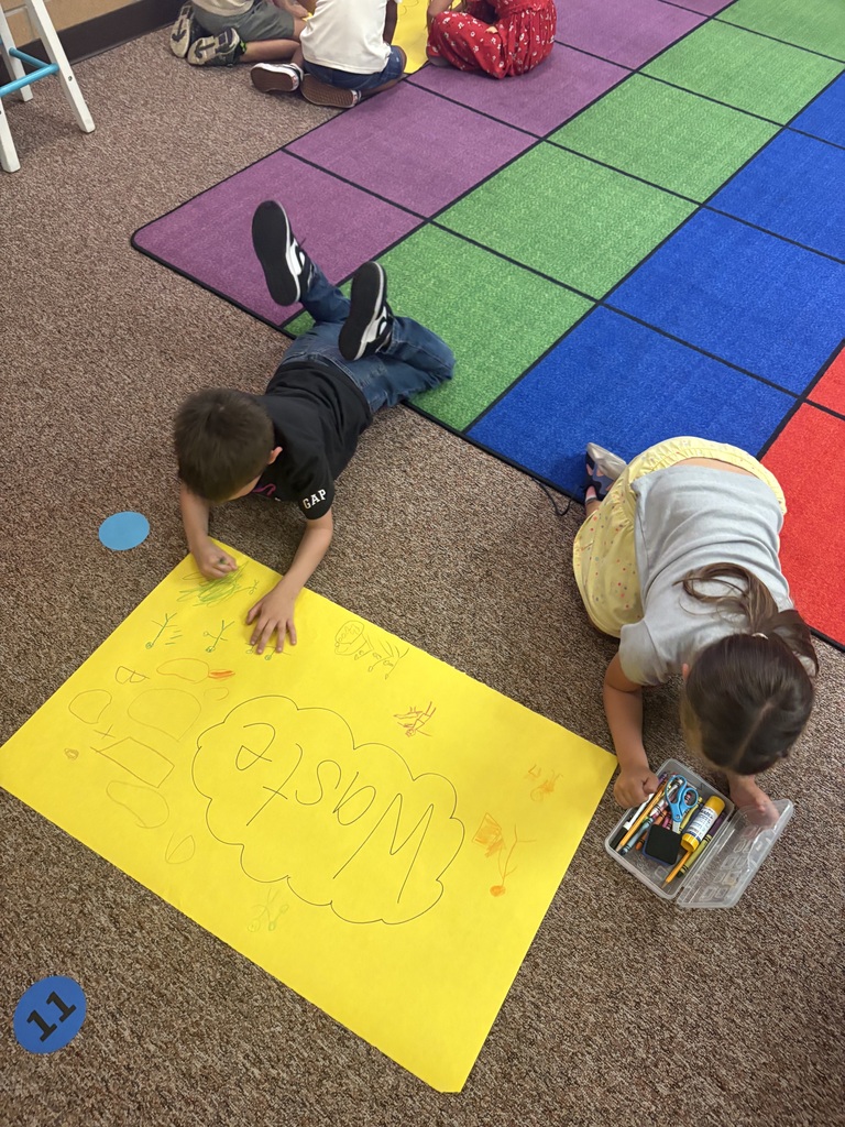 students writing on a poster together