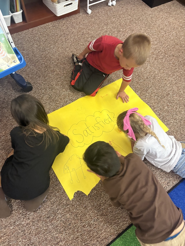 students writing on a poster together