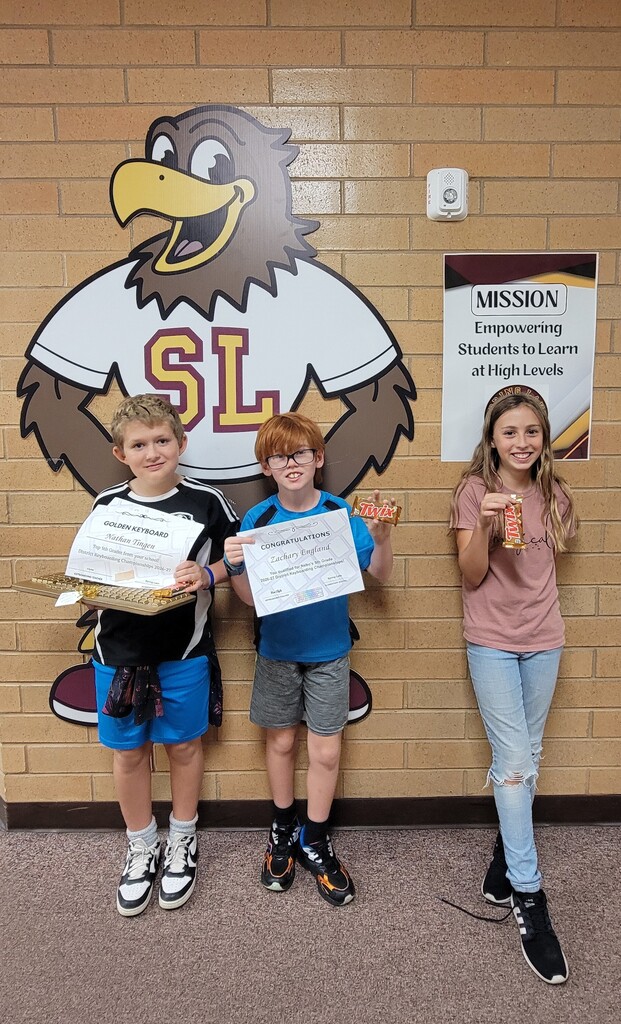 5th graders showing their certificates and treats