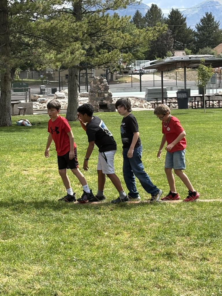 5th graders work together to walk on skis 