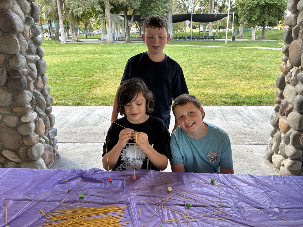 kids making a sculpture from spaghetti noodles and gumdrops