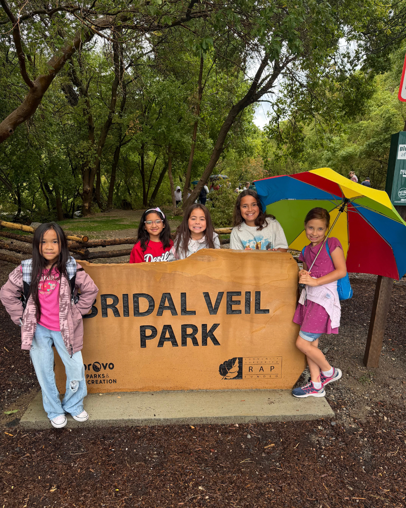 students posing with a bridal veil park sign 