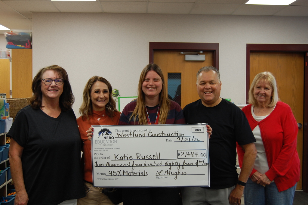 Mrs. Russell reviecing a large check