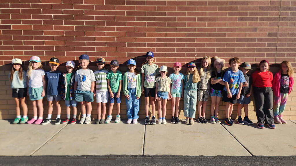 Foothills Elementary students participating in Road Safety Day during Ribbon Week. Students are wearing green clothing and a variety of hats to show their support for road safety.
