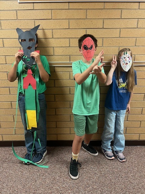 Fifth-grade students showing their Maya-inspired masks.