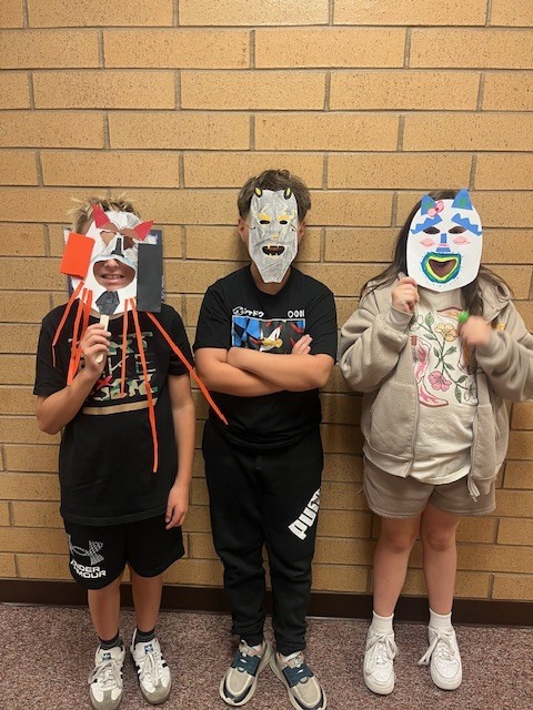 Fifth-grade students showing their Maya-inspired masks.