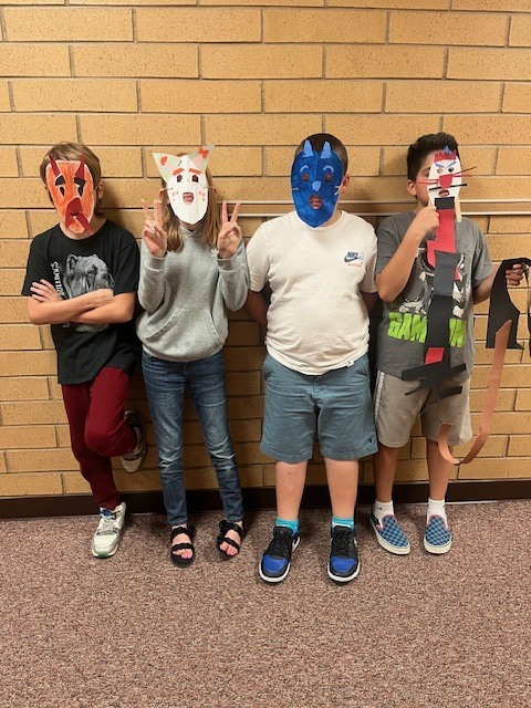 Fifth-grade students showing their Maya-inspired masks.