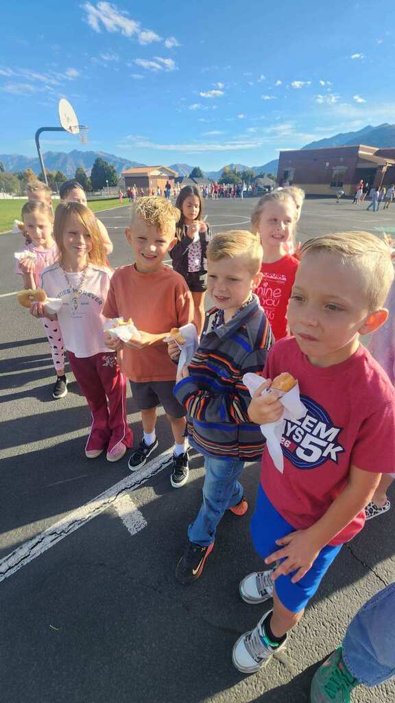 Students wearing red and enjoying donuts together for Drug Prevention Day.