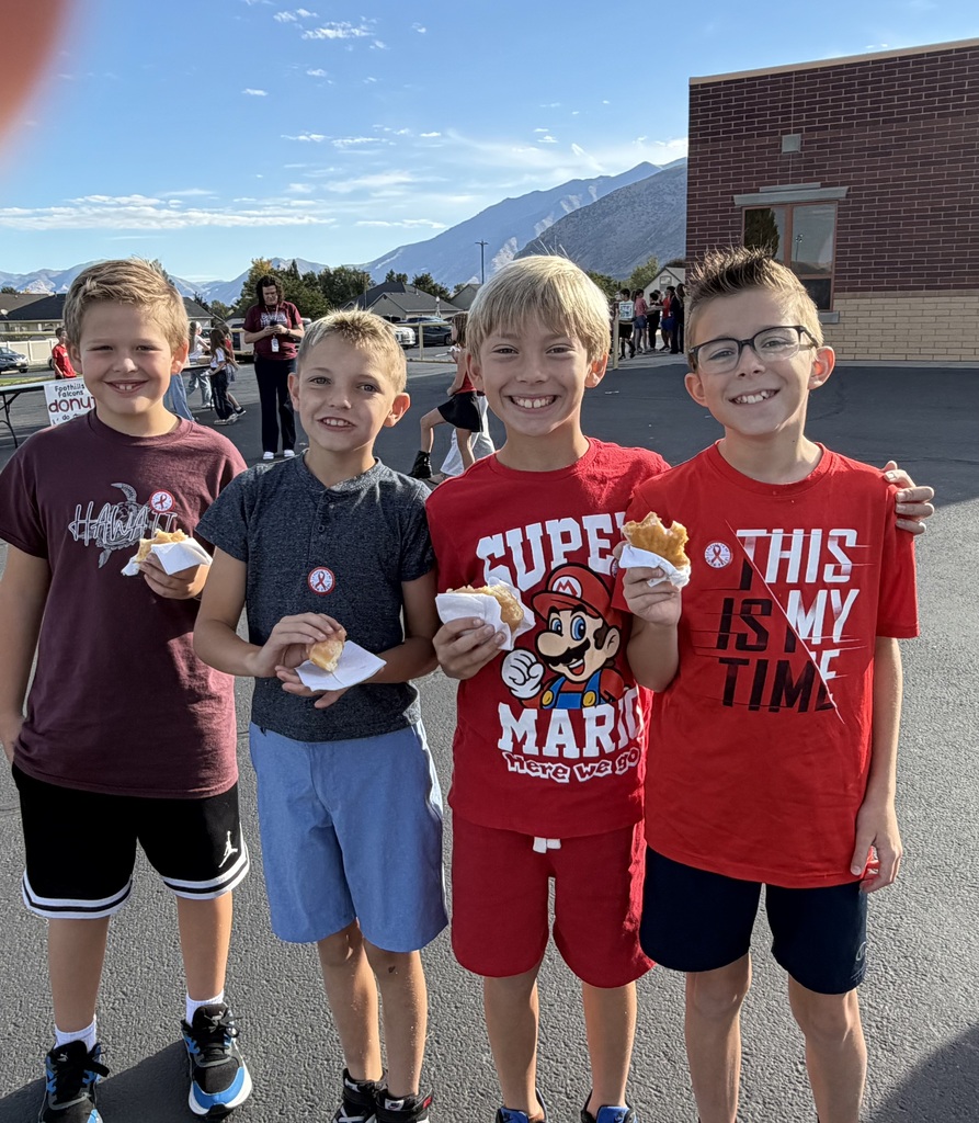 Students wearing red and enjoying donuts together for Drug Prevention Day.