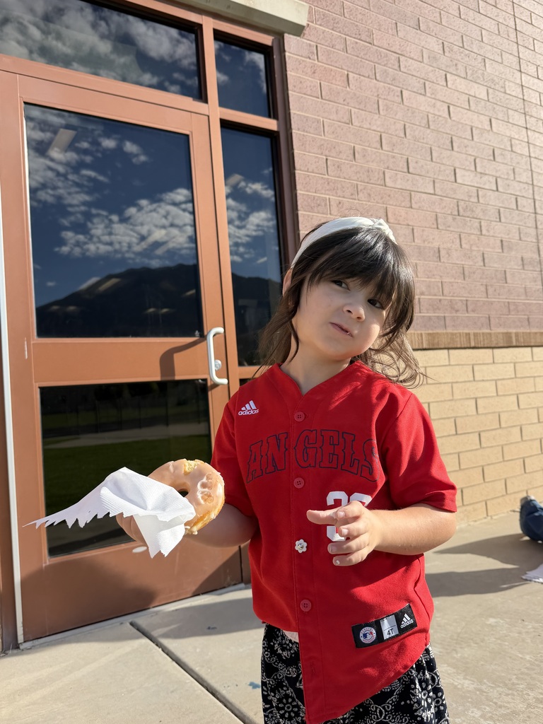 Students wearing red and enjoying donuts together for Drug Prevention Day.