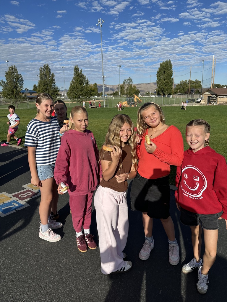 Students wearing red and enjoying donuts together for Drug Prevention Day.