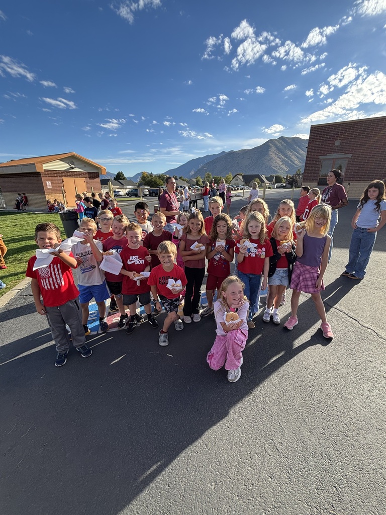 Students wearing red and enjoying donuts together for Drug Prevention Day.