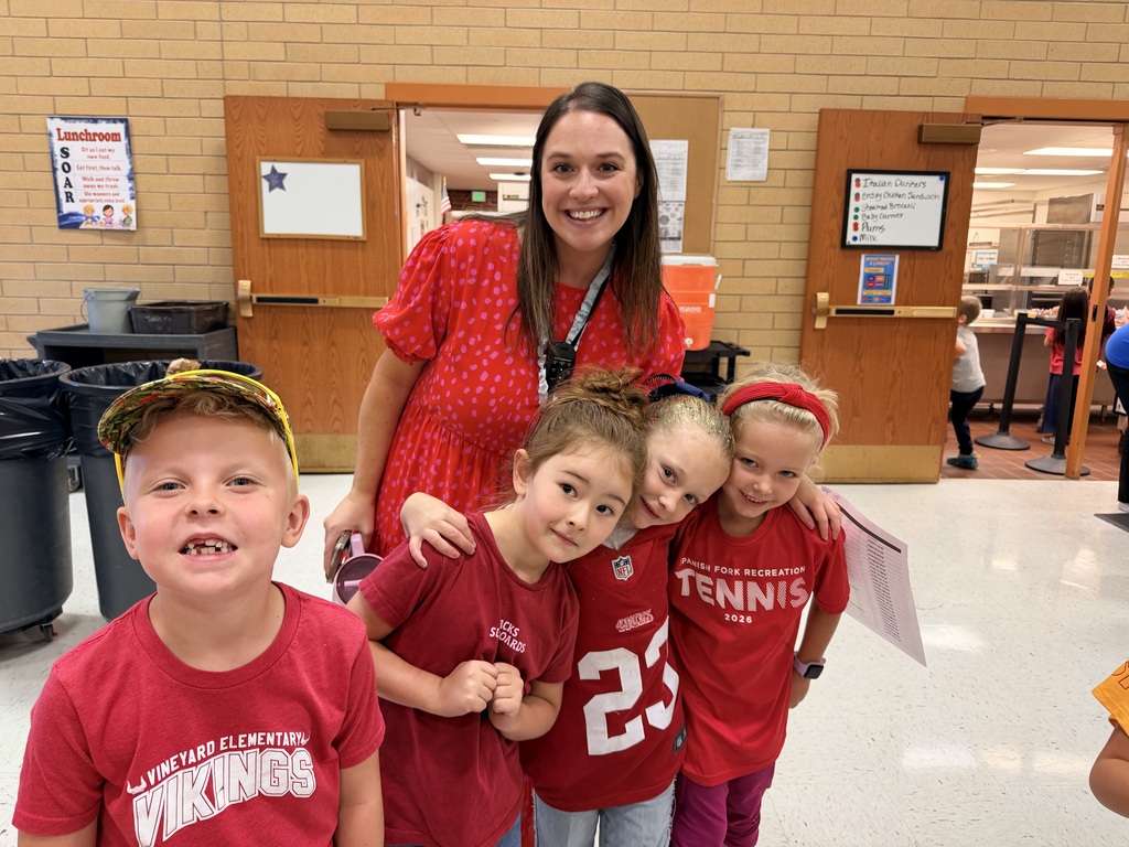 Students wearing red and enjoying donuts together for Drug Prevention Day.