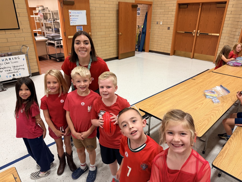 Students wearing red and enjoying donuts together for Drug Prevention Day.