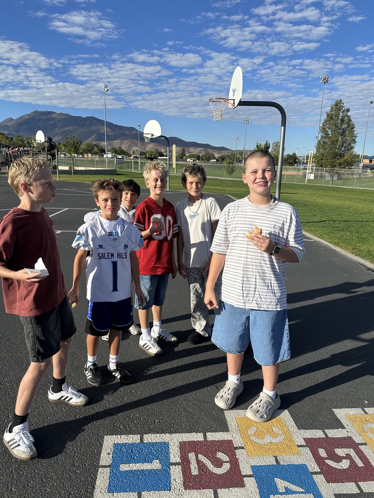 Students wearing red and enjoying donuts together for Drug Prevention Day.