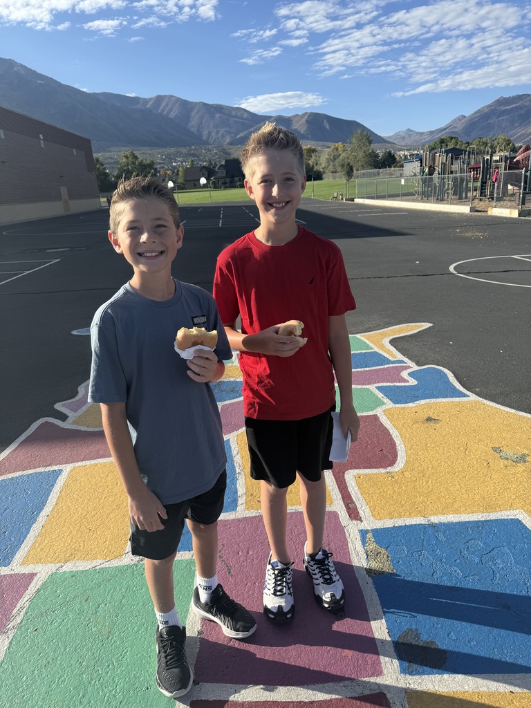 Students wearing red and enjoying donuts together for Drug Prevention Day.