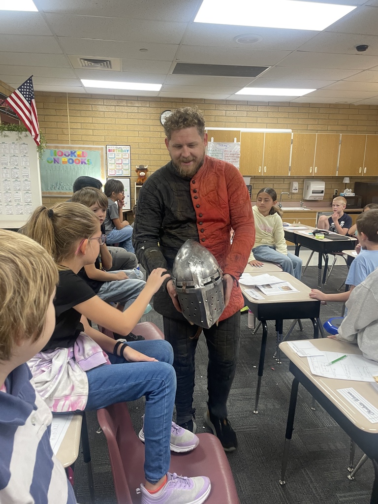Kids looking at Knight helmet