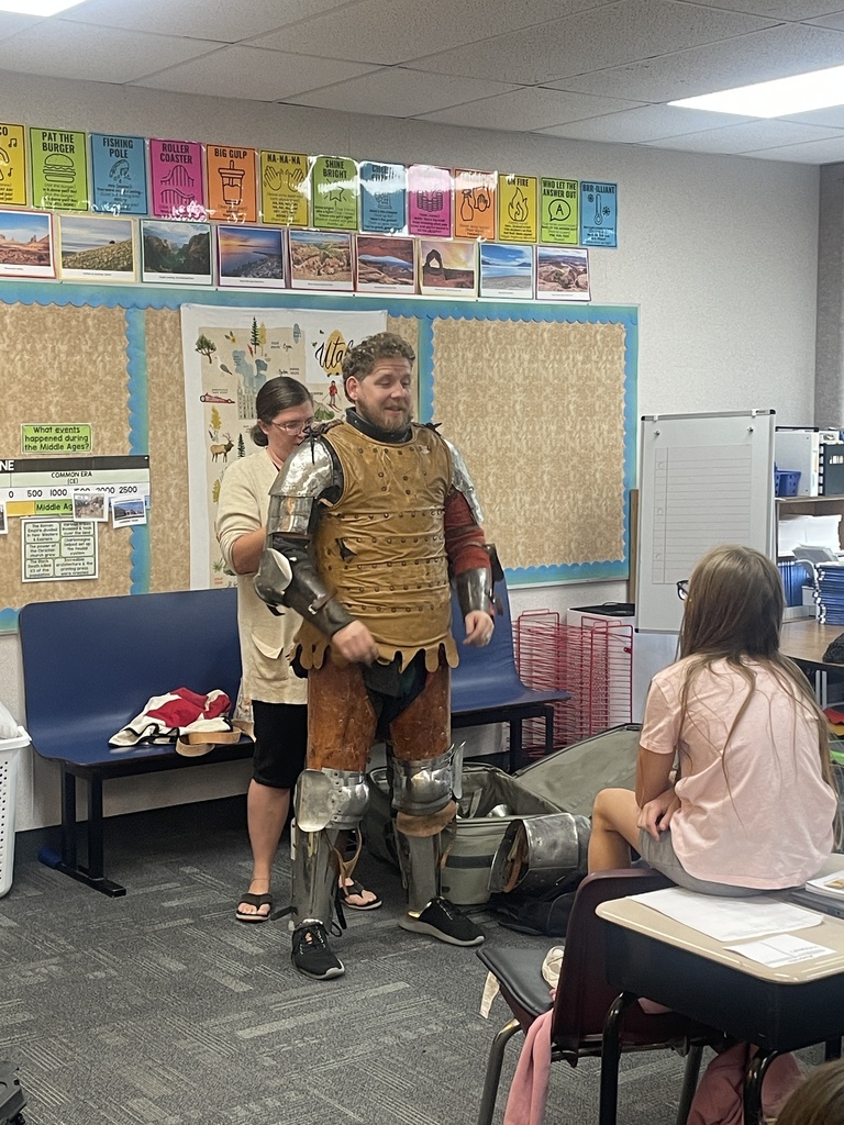 Man putting on  a whole knight armour