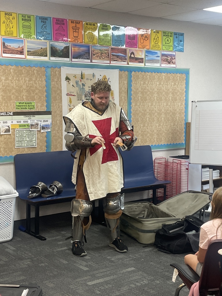 Parent showing students a knight uniform