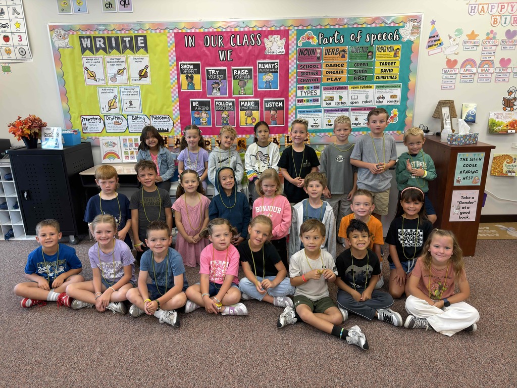Students sitting in a first grade classroom wearing gold.