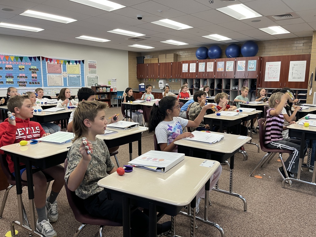 students using musical instruments to help learn place value 