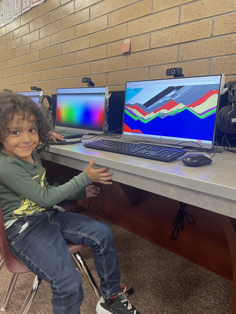 student smiling while on the computers