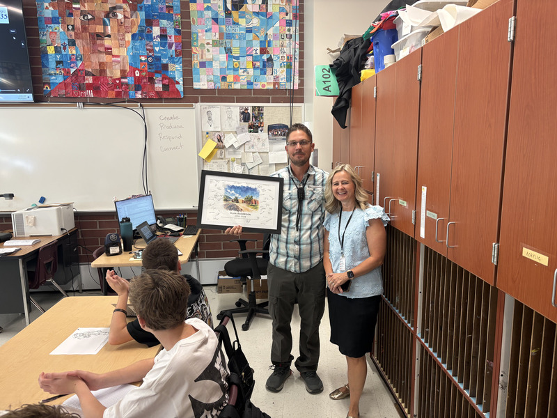 Faculty member receiving painting