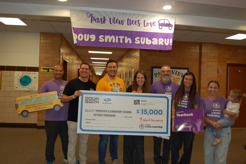 Doug Smith Subaru employees with Mrs. Jarvis and Mr. Evans