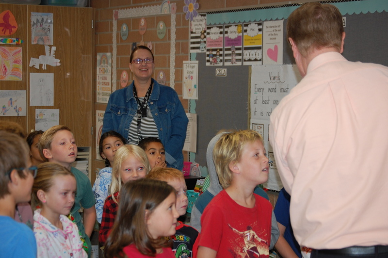Mrs. Hunter and students listening to Superintendent Nielsen