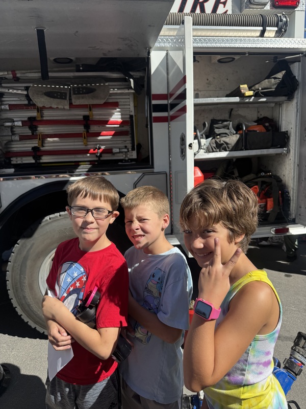 kids standing outside a fire truck