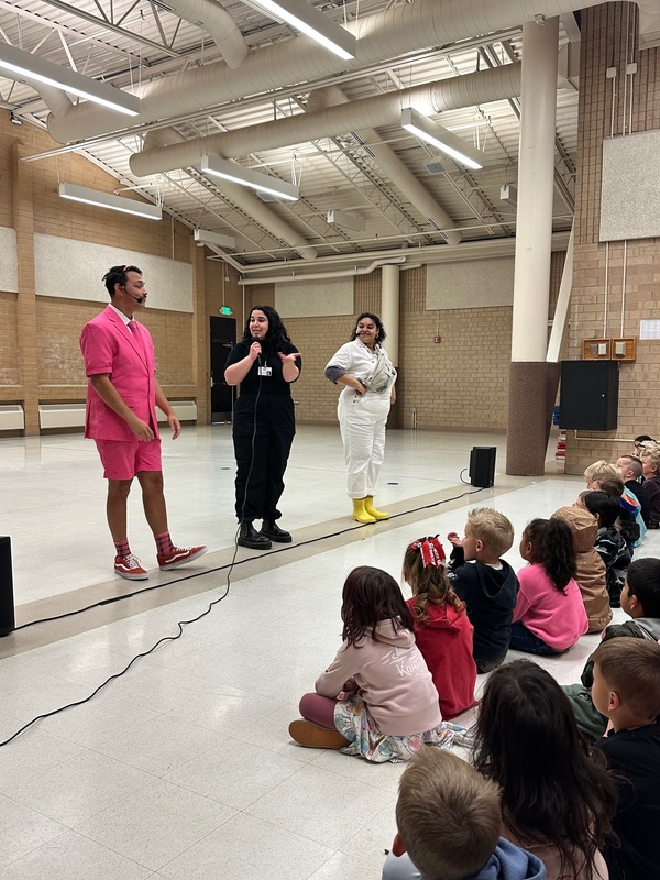 3 actors performing for students