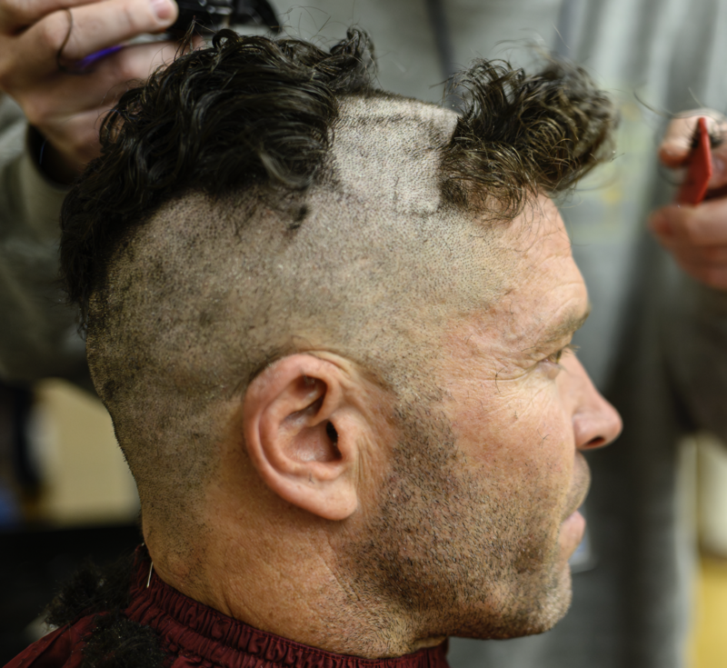 Teacher getting his head shaved in the make a wish assembly
