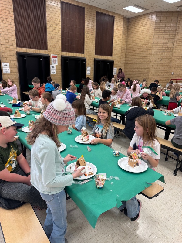 students  making gingerbread houses