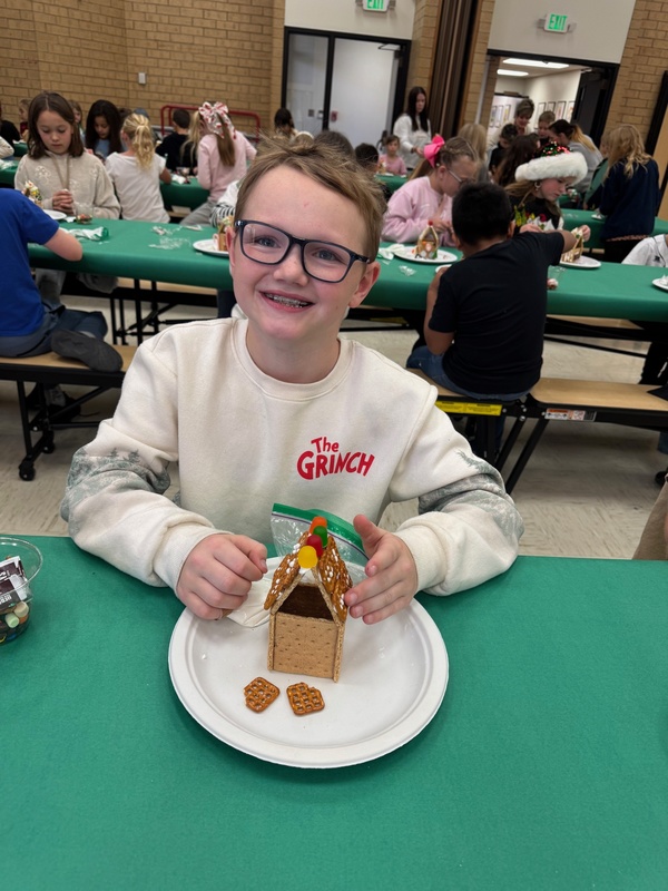 student making gingerbread house