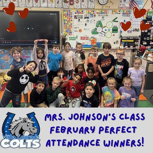 Group of young students posing outside a classroom with a trophy, smiling and sitting together. Red heart graphics surround them. Text reads “Mrs. Johnson's Class January Perfect Attendance Winners” with Vista Colorado Colts logo.