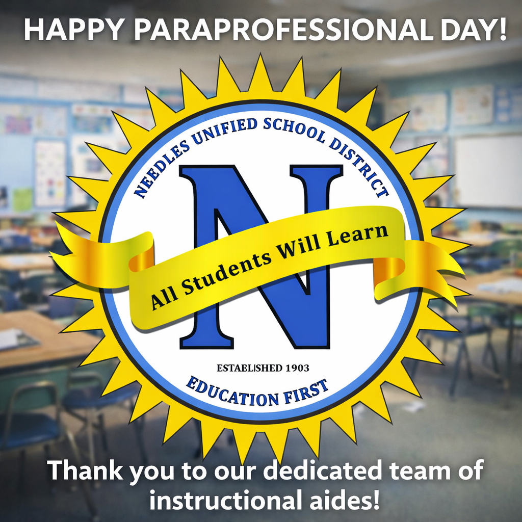 Alt text: A school district appreciation graphic for Paraprofessional Day. The background shows a blurred classroom with desks and chairs. Centered is a large circular logo for Needles Unified School District featuring a blue “N” and a yellow sunburst border. A gold ribbon across the logo reads “All Students Will Learn.” At the top, bold white text says “HAPPY PARAPROFESSIONAL DAY!” At the bottom, white text reads, “Thank you to our dedicated team of instructional aides!” The overall tone is celebratory and appreciative, highlighting school support staff.