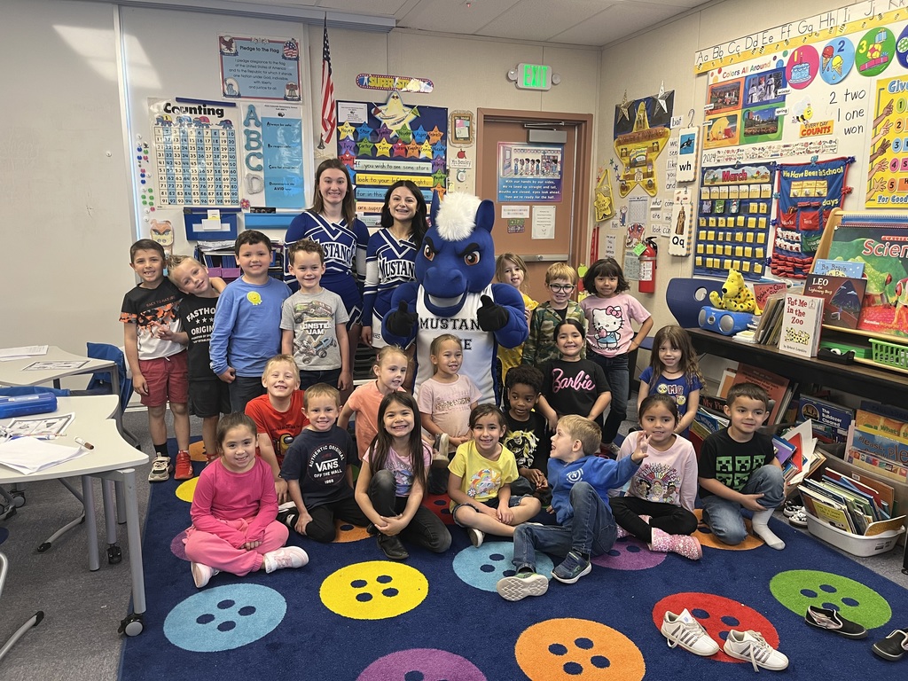 Cheerleaders and mascot with students.