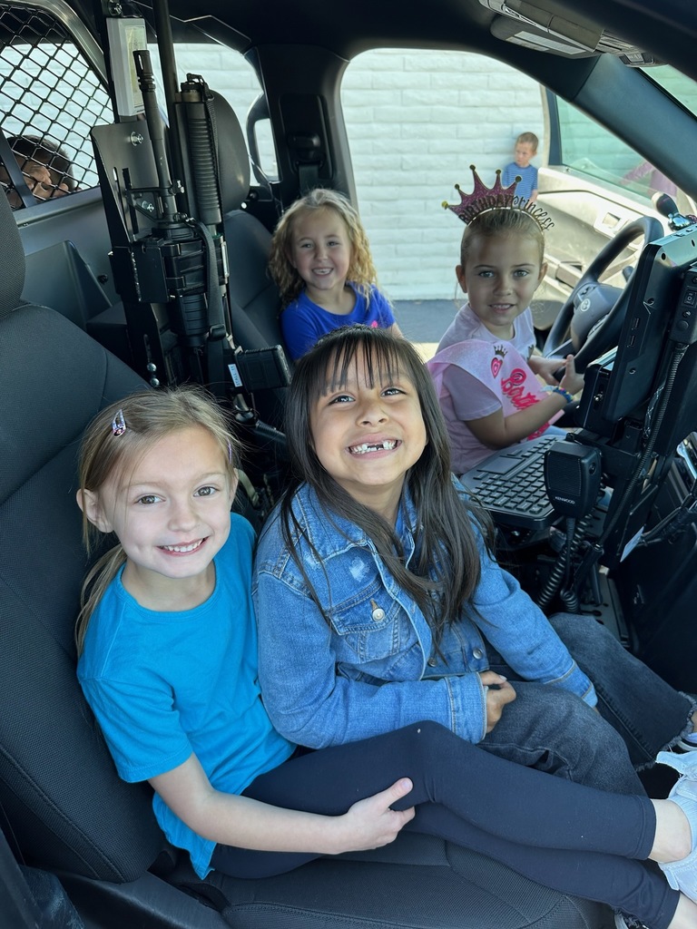 Students sitting in patrol car.