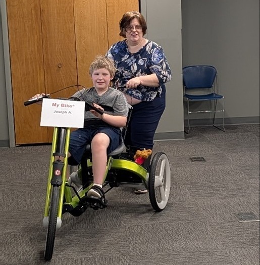 A happy recipient of an adapted bike.