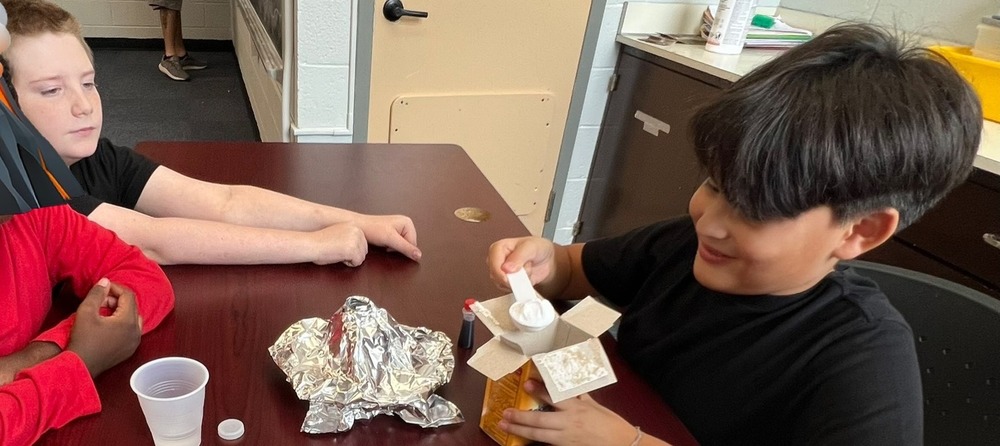 School age students working on volcano project