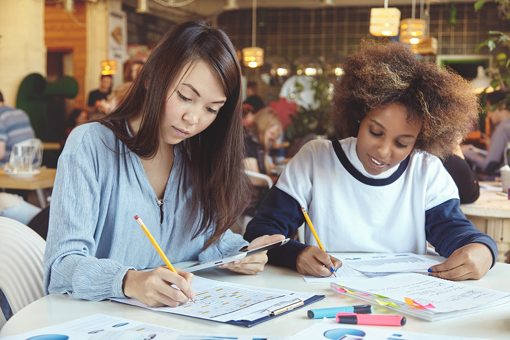 2 teachers looking at student work Image by WayHome Studio found on FreePik