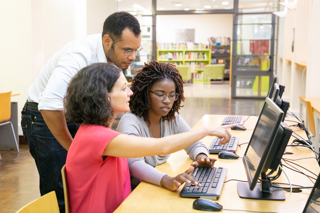 Freepik stock image; teachers working on a computer together