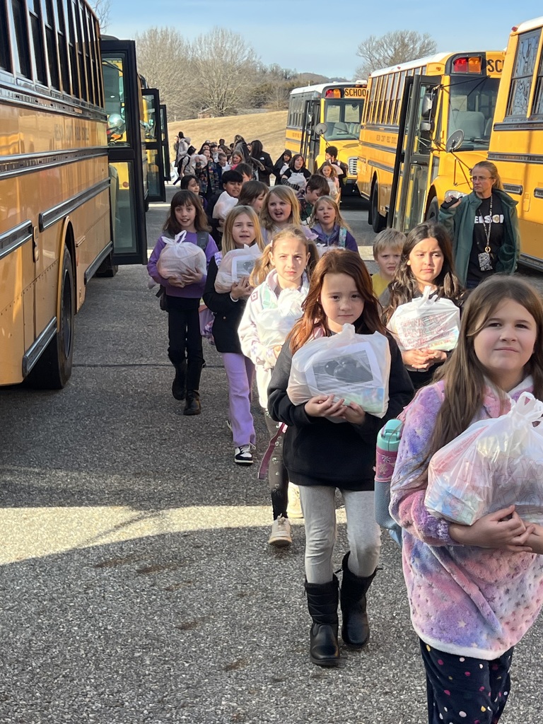 Winter Storm Fern Meal Distribution - kids carry bags out to buses