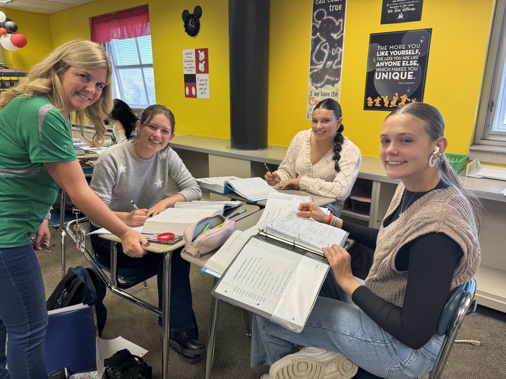 NCHS teachers and students working in a small groups for Plus Time