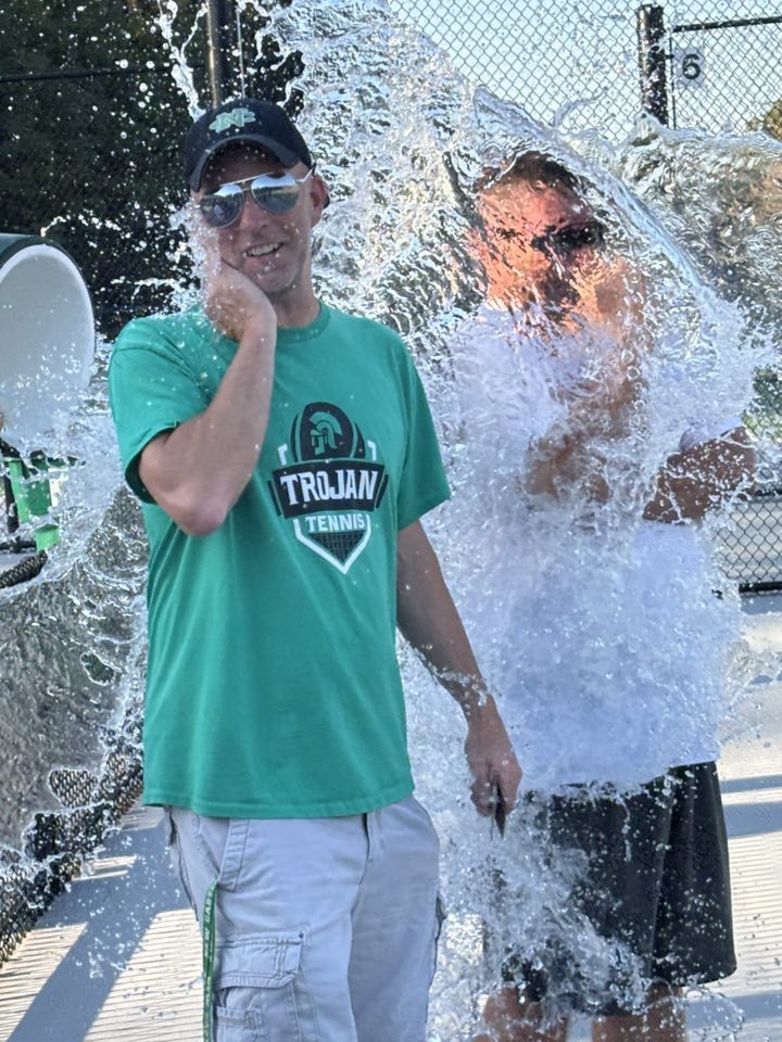 Tennis coaches getting drenched with water
