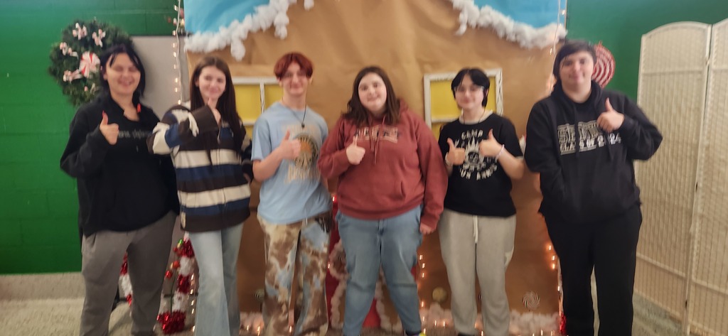 JAG students posing in front of Gingerbread House